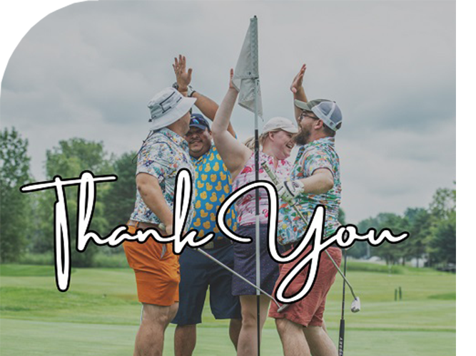 group of golfers high fiving at a hole with 